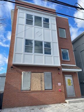 Newark apartment for rent - the front of a brick building with a large window