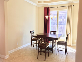 Pearland house for rent - a dining room with a table and chairs and a window