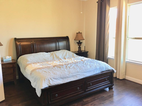 Pearland house for rent - a bedroom with a bed and two windows
