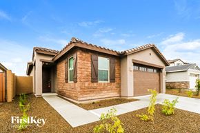 Glendale house for rent - A house with a brown exterior and a white garage door is for sale.