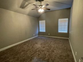 Greenville house for rent - A room with a ceiling fan and carpeted floor.