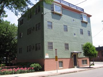 Chelsea apartment for rent - a green and pink building on the corner of a street