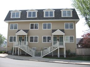 Everett apartment for rent - a yellow house with a front porch and stairs