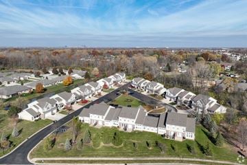 Indianapolis townhouse for rent - A suburban neighborhood with houses and trees.