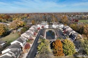 Indianapolis townhouse for rent - A suburban neighborhood with houses and a pond.