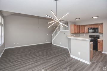 Indianapolis townhouse for rent - A modern kitchen with wooden cabinets and a stainless steel oven.