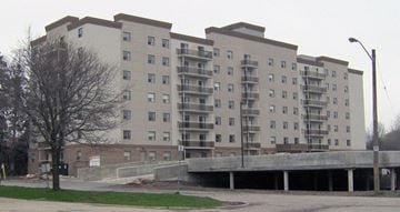 Waterloo apartment for rent - A large apartment building with a parking garage in front.