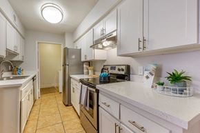 Glendale apartment for rent - a kitchen with white cabinets and a stainless steel refrigerator