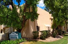 Phoenix apartment for rent - a building with a sign in front of it and some trees