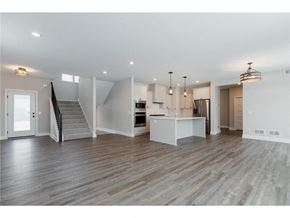 Woodbury house for rent - an open kitchen and living room with a staircase