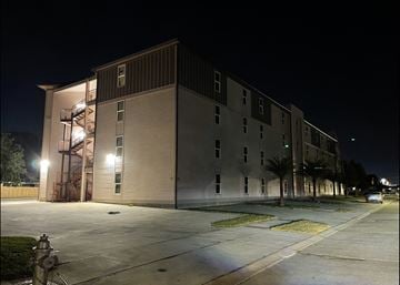 Metairie apartment for rent - a large building at night with a fire hydrant