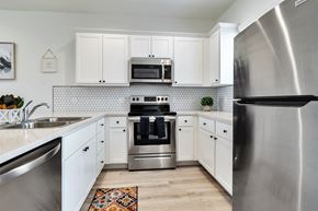 Phoenix apartment for rent - a kitchen with stainless steel appliances and white cabinets