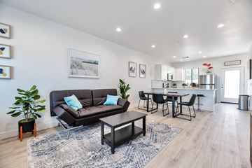 Phoenix apartment for rent - a living room with a couch and a table with chairs
