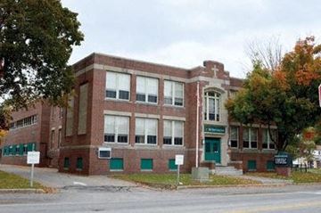 Laconia apartment for rent - a red brick building on the corner of a street