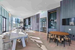 Honolulu apartment for rent - A modern dining room with a long table and chairs.