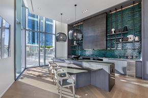 Honolulu apartment for rent - A modern kitchen with a large island and chairs.