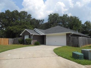 Pensacola house for rent - a house with a driveway and a garage door