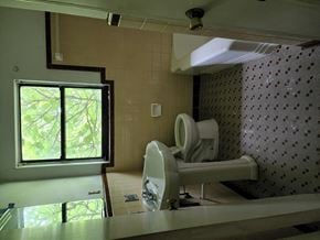 Pensacola house for rent - a bathroom with two urinals and a sink and a window