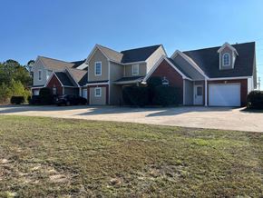 Collins apartment for rent - A large house with a red roof and a garage.