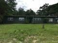 Pensacola house for rent - a house with a field in front of it