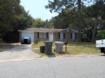 Pensacola house for rent - a small house with a car parked in front of it