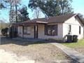 Pensacola house for rent - a small white house with a brown roof and some trees