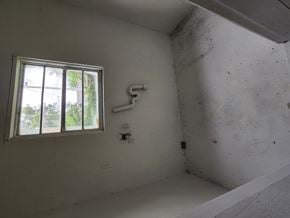 Pensacola house for rent - a small room with a window and a white wall