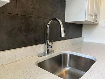 Fort Myers apartment for rent - A modern kitchen sink with a chrome faucet.