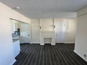 Fort Myers apartment for rent - A room with a fireplace and wood flooring.