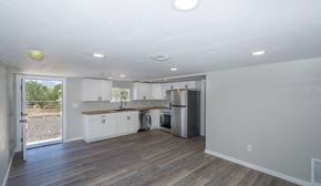 Tucson house for rent - A kitchen with white cabinets and a wooden countertop.