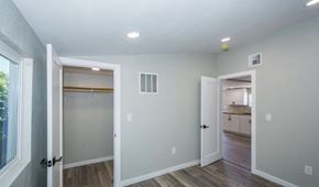 Tucson house for rent - A room with a doorway leading to a kitchen and a window on the left.