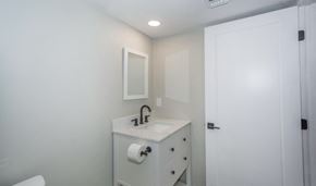 Tucson house for rent - A white bathroom with a sink and mirror.