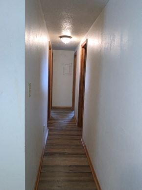 Crestview house for rent - a hallway with wooden floors and a light on the ceiling