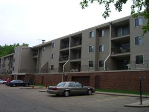 Stillwater apartment for rent - an apartment building with cars parked in a parking lot