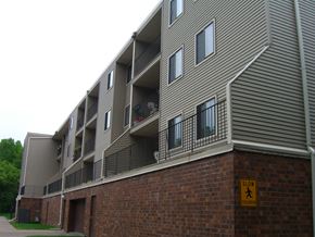 Stillwater apartment for rent - the exterior of an apartment building with a street sign