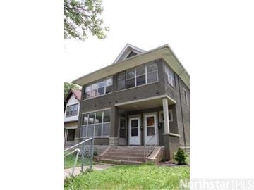 Minneapolis apartment for rent - A two-story house with a front porch and a garage door.