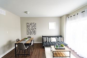 Ottawa apartment for rent - A modern living room with a dining table and a couch.