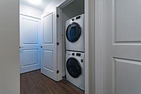 Ottawa apartment for rent - A washing machine is in a small space between two doors.