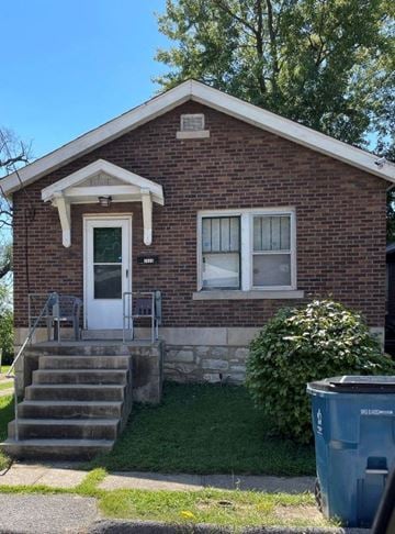 St Louis house for rent - A small brick house with a white door and a small porch.
