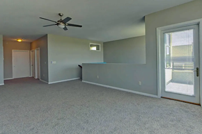 West Des Moines apartment for rent - an empty living room with a ceiling fan and a window