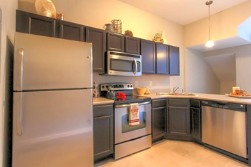 West Des Moines apartment for rent - a kitchen with stainless steel appliances and black cabinets