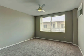 West Des Moines apartment for rent - an empty room with a ceiling fan and a window