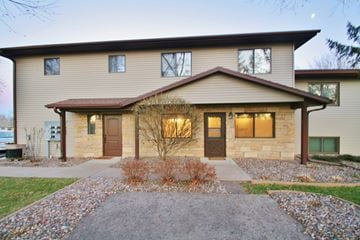 Rochester apartment for rent - the front of a house with a walkway and a driveway