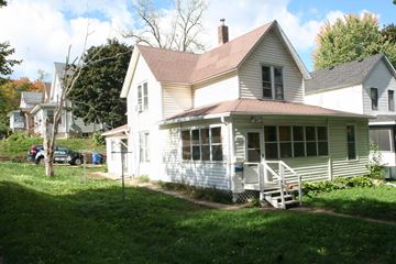 Red Wing apartment for rent - a white house with a porch and a lawn