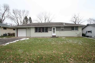 Red Wing house for rent - the front of the house with a lawn and a white garage door