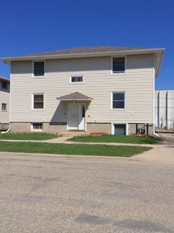 Rochester apartment for rent - A two-story house with a garage door on the first floor.