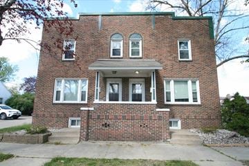 Rochester apartment for rent - a brick building with three windows and a sidewalk