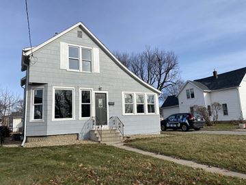 Rochester house for rent - a white house with a car parked outside of it