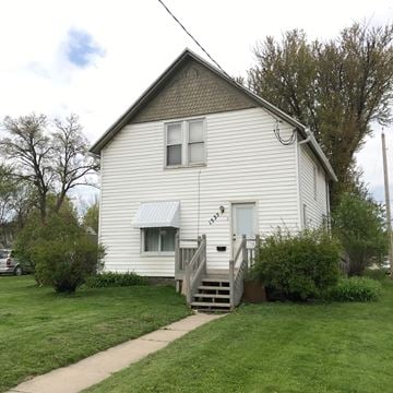 Rochester apartment for rent - A white house with a grey roof and a small front porch.