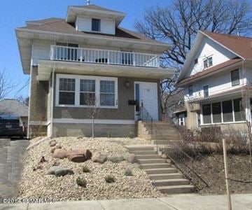 Rochester apartment for rent - a house with stairs and a yard with rocks